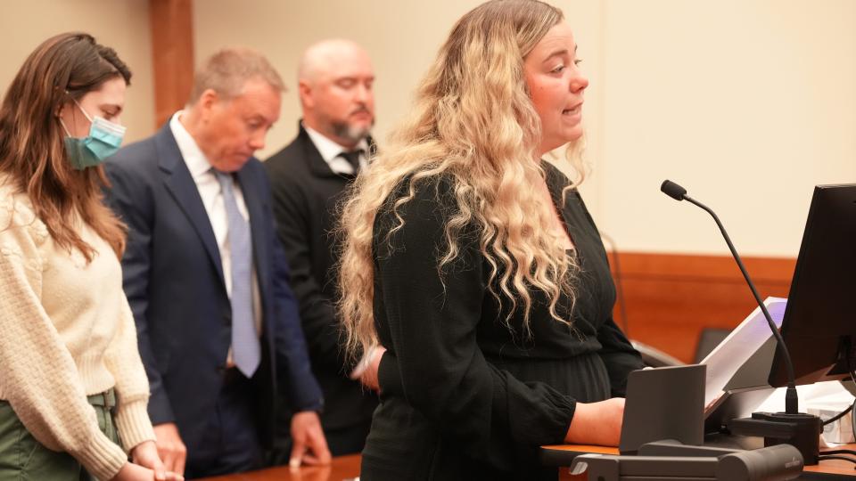 Madison Sparks, 24, addresses the court and former South-Western City School District teacher and coach Benjamin Rutan (behind her, right), 42, of Grove City, as he is sentenced for sexually abusing her beginning when she was 14 years old in 2013. Rutan was sentenced to six years in prison. From left in photo are victim advocate Mickaela Maloney, Rutan's attorney Bradley Koffel, Rutan and Sparks.