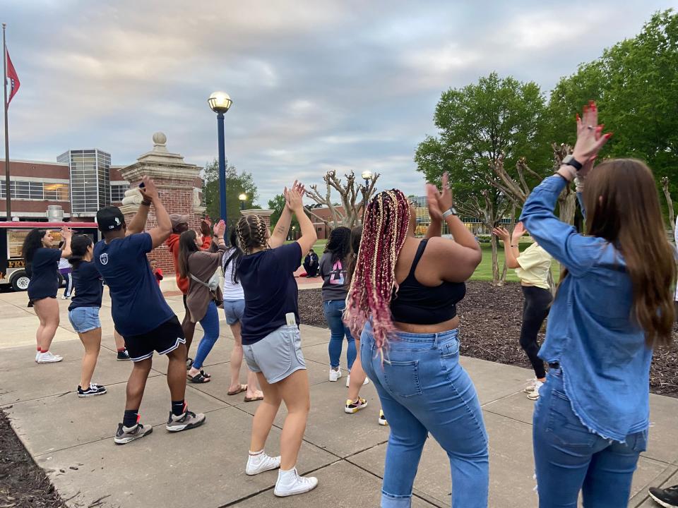 Students dance to the cha-cha slide after the kickball tournament hosted by the MOX and IDEAL Women.