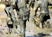 <p>Participants leave the pitch after their match at the so called “Wattoluempiade” (Mud Olympics) in Brunsbuettel at the North Sea, Germany July 30, 2016. (REUTERS/Fabian Bimmer) </p>