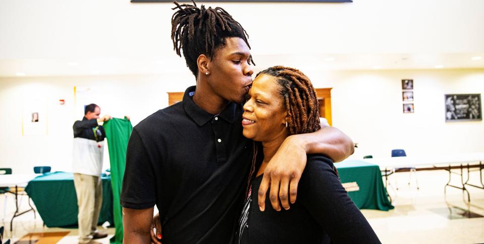 Dunbar High School football player, Demetrie Morgan hugs his mother, Demetria Buchanan after signing with McDougle Technical Institute during a signing day at the school on Tuesday, April 19, 2022.