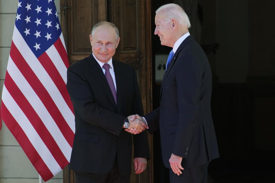 FILE - Russian President Vladimir Putin, left, and U.S President Joe Biden shake hands in Geneva, Switzerland, on June 16, 2021. Biden may feel an incentive to secure Wall Street Journal reporter Evan Gershkovich's release because of boasts by former President Donald Trump, who is his main challenger in this year's election, that he can easily get the journalist freed. The Kremlin says it has not been in touch with Trump. (AP Photo/Alexander Zemlianichenko, Pool, File)