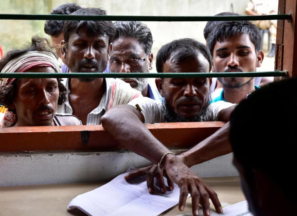 Indian villagers check their names on the final register of citizens at the NRC office in Morigaon, Assam, on 31 August 2019.