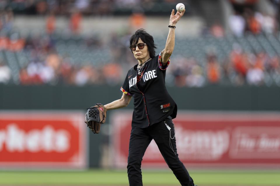 Rock and roll music icon Joan Jett throws the ceremonial first pitch before a baseball game between the Baltimore Orioles and the Texas Rangers, Friday, June 28, 2024, in Baltimore. (AP Photo/Stephanie Scarbrough)