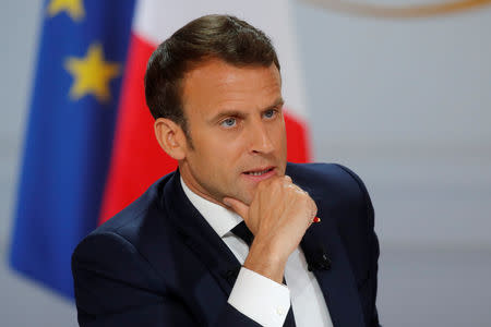 FILE PHOTO: French President Emmanuel Macron reacts as he speaks during a news conference to unveil his policy response to the yellow vests protest, at the Elysee Palace in Paris, France, April 25, 2019. REUTERS/Philippe Wojazer