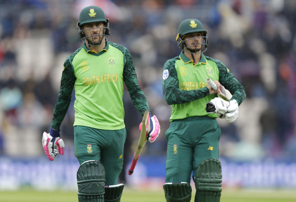 South Africa's captain Faf du Plessis, left, and South Africa's Quinton de Kock leave the pitch as rain stops play during the World Cup cricket match between South Africa and the West Indies at The Ageas Bowl in Southampton, Monday, June 10, 2019. (AP Photo/Kirsty Wigglesworth)