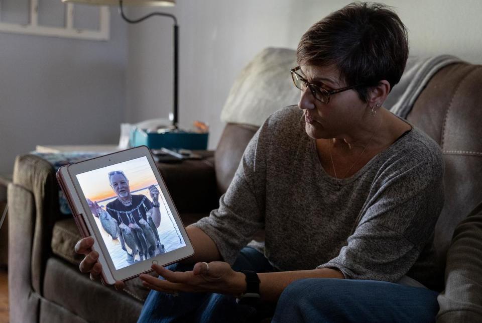 Michelle Simington, Mike’s daughter in law, shows a photo of him fishing before he knew he had cancer. “As a nurse there’s no excuse, if you did a biopsy, you are waiting for those results,” she said when talking about Mike’s cancer.