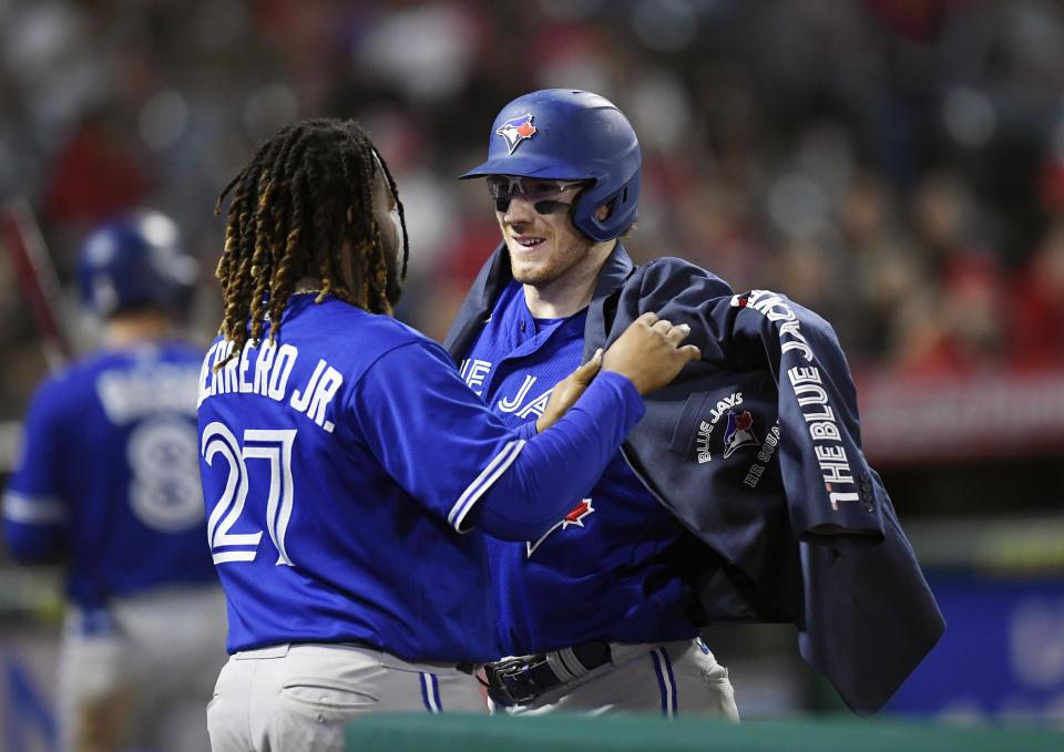 ANAHEIM, CA - MAY 26: Danny Jansen #9 of the Toronto Blue Jays receives the Home Run jacket from Vladimir Guerrero Jr. #27 of the Toronto Blue Jays after he hit a solo home run against Los Angeles Angels during the ninth inning at Angel Stadium of Anaheim on May 26, 2022 in Anaheim, California. (Photo by Kevork Djansezian/Getty Images)