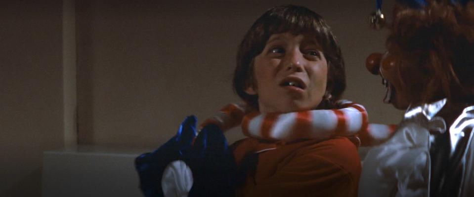 Robbie being choked by a clown in "Poltergeist"