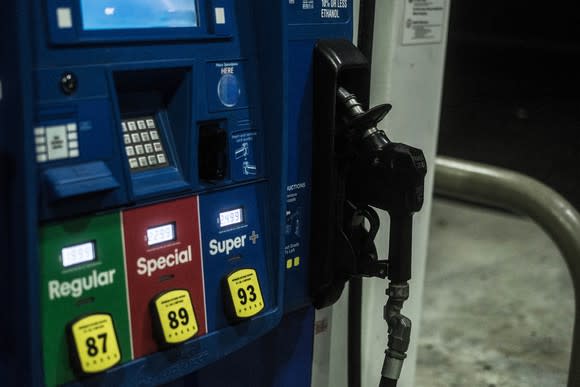 regular, special, and super+ gas pumps next to each other at a gas station