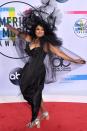 <p>The legendary singer certainly went all out with her look for this year's AMAs. The 73-year-old stepped out wearing a statement headpiece to match her black gown and tulle cape. She definitely made an entrance.</p>