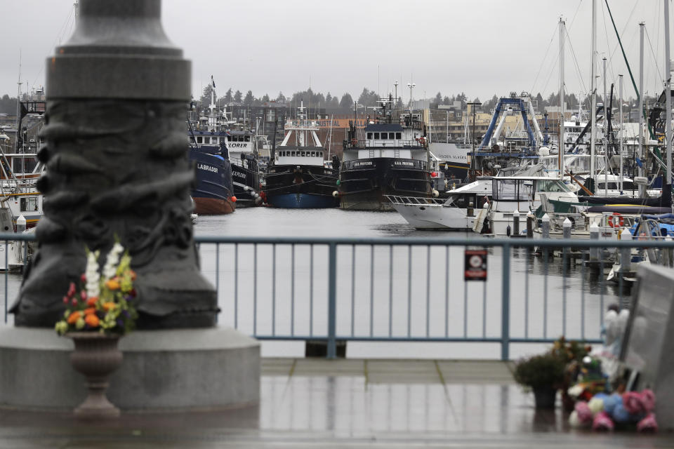 Fishing and boats used for other purposes are shown parked near the Seattle Fishermen's Memorial, Thursday, Jan. 2, 2020, in Seattle. Items left at the memorial Thursday included a ball cap with the name of the crab fishing boat Scandies Rose, a 130-foot crab fishing boat from Dutch Harbor, Alaska, that sank on New Year's Eve. (AP Photo/Ted S. Warren)