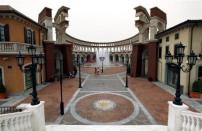 Two women walk through a building that resembles a Roman Coliseum at the Florentia Village in the district of Wuqing, located on the outskirts of the city of Tianjin June 13, 2012. <br><br><a href="http://news.yahoo.com/photos/china-replicates-austrian-village-slideshow/" data-ylk="slk:Click here;elm:context_link;itc:0;sec:content-canvas;outcm:mb_qualified_link;_E:mb_qualified_link;ct:story;" class="link  yahoo-link">Click here</a> to see a related gallery: China replicates Austrian village