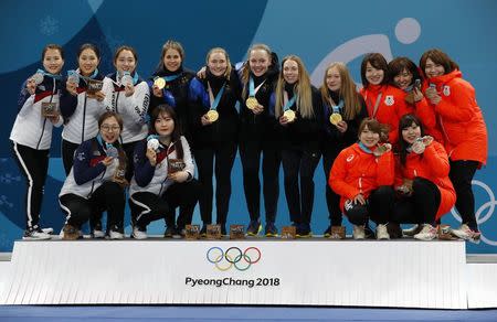 Curling - Pyeongchang 2018 Winter Olympics - Women's Final - Sweden v South Korea - Gangneung Curling Center - Gangneung, South Korea - February 25, 2018 - Silver medallists from South Korea, gold medallists from Sweden and bronze medallists from Japan pose during the victory ceremony. REUTERS/Phil Noble