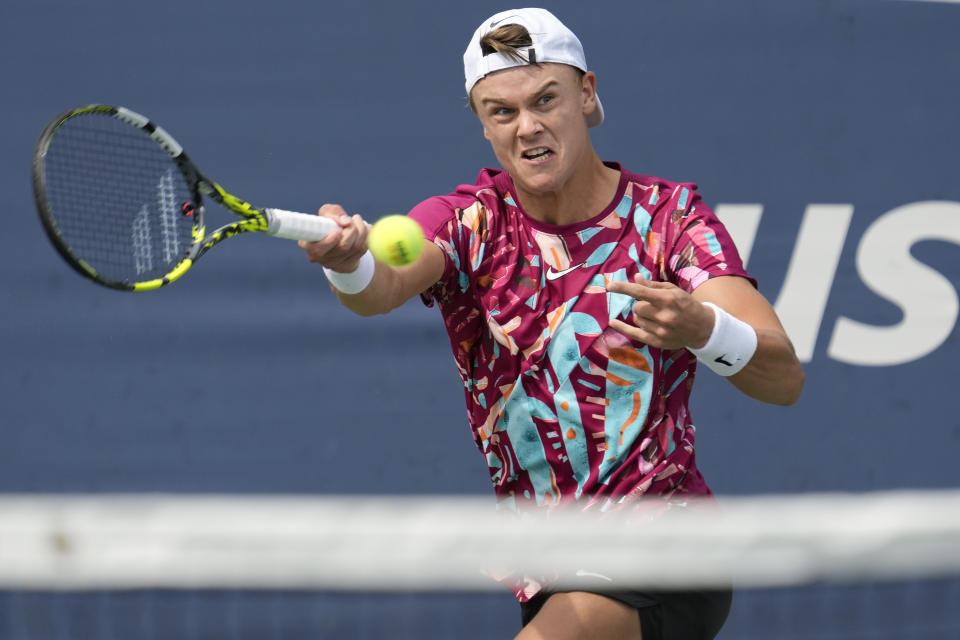 Holger Rune, of Denmark, returns a shot to Roberto Carballes Baena, of Spain, during the first round of the U.S. Open tennis championships, Monday, Aug. 28, 2023, in New York. (AP Photo/John Minchillo)