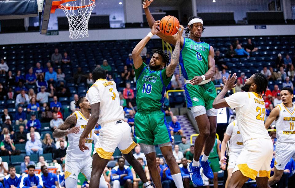 FGCU’s  Zach Anderson  and Dahmir Bishop go for rebound   against Northern Kentucky at the Gulf Coast Showcase at Hertz Arena. FGCU won and moves on to play Drexel.  