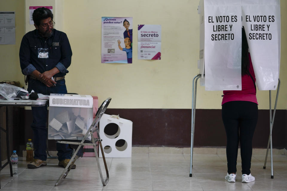 A woman casts her ballot during the local state elections in Texcoco, Mexico state, Sunday, April 4, 2023. (AP Photo/Eduardo Verdugo)