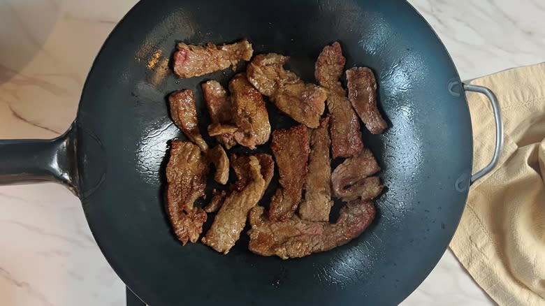 steak strips stir frying in wok