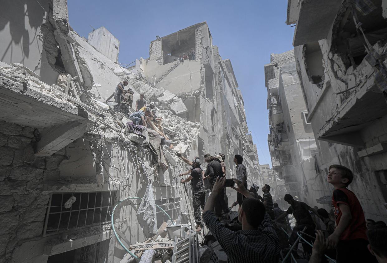 IDLIB, SYRIA - MAY 27 : Civil defence crews and locals conduct search and rescue works after airstrikes by Assad Regime hit the de-escalation zone of Ariha in Idlib, Syria on May 27, 2019. 9 people were reported killed and 28 injured.  (Photo by Muhammed Said/Anadolu Agency/Getty Images)