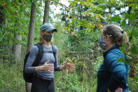 In this photo provided by the University of Maryland, University of Maryland Professor Kate Tully, left, talks with University of Delaware Professor Holly Michael about using the St. Jones Reserve south of Dover, Delaware, as a research site for a $4.3 million National Science Foundation grant to study the transforming effects of invading saltwater on the Delmarva Peninsula. (Hannah Fields/University of Maryland via AP)