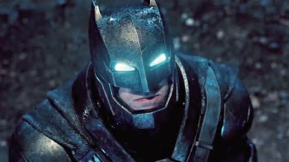 A power-suited up Batman looks up into the sky in 2016's Batman vs Superman