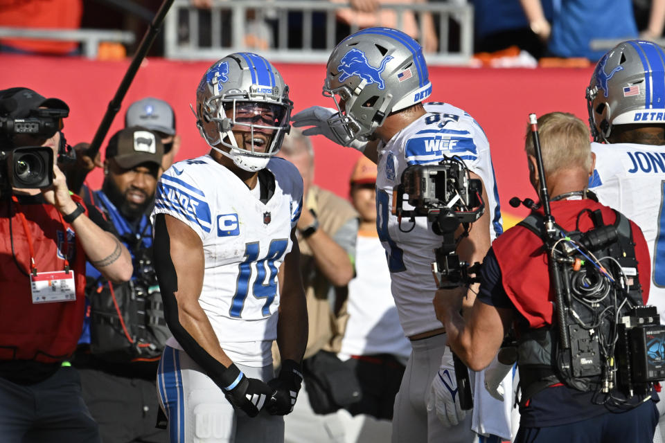 Detroit Lions wide receiver Amon-Ra St. Brown (14) celebrates his 27-yard touchdown reception with Brock Wright (89) during the first half of an NFL football game against the Tampa Bay Buccaneers Sunday, Oct. 15, 2023, in Tampa, Fla. (AP Photo/Jason Behnken)