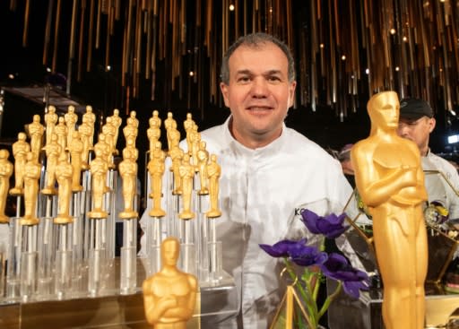 Pastry chef Kamel Guechida poses with chocolate Oscars at the Governors Ball press preview in Hollywood on January 31