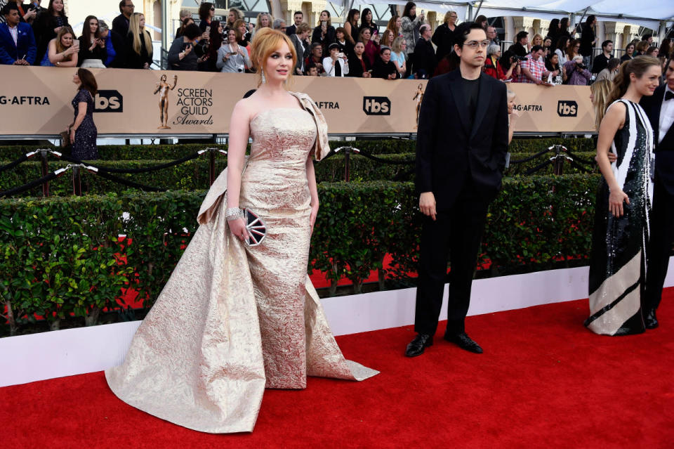 Christina Hendricks in a gold gown with a train by Christian Siriano at the 22nd Annual Screen Actors Guild Awards at The Shrine Auditorium on January 30, 2016 in Los Angeles, California.