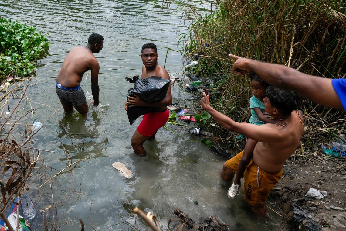 Migrants cross the Rio Grande to the U.S. side, from Matamoros, Mexico, Thursday, May 11, 2023. Migrants rushed across the Mexico border Thursday in hopes of entering the U.S. in the final hours before pandemic-related asylum restrictions are lifted. (AP Photo/Fernando Llano)