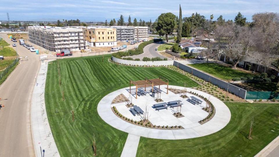 An aerial view shows a new green space/park located next to Sarah’s Court, an affordable housing project under construction, and Brandhaven Senior Living in the Fancher Creek Town Center shopping center project on Clovis Avenue and Tulare Street in southeast Fresno.