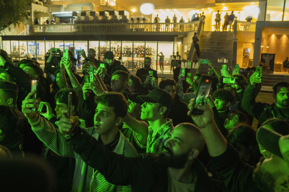 Youths gather along the Tigris River for a concert by rap artist OG Khalifa in Baghdad, Iraq, Saturday Feb. 25, 2023. One of the songs he performed mocks “sheikhs,” those who wield power in the new Iraq through wealth or political connections. (AP Photo/Jerome Delay)