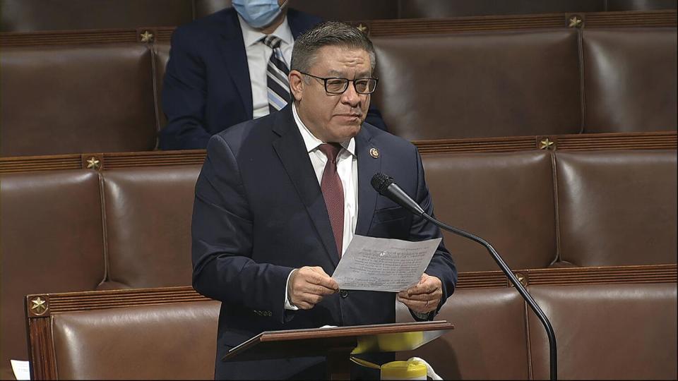 A man holding a paper speaks on the floor of the House of Representatives at the U.S. Capitol in Washington.