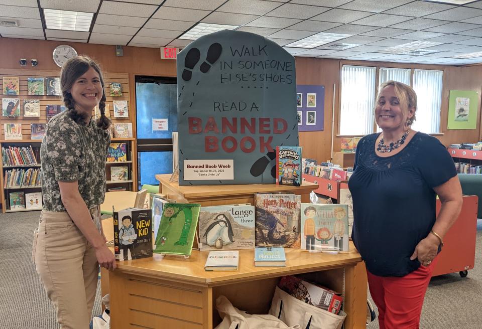 Librarians Wendy Kirchner, right, and Jessica Beaudoin stand next to a Banned Book Week display at the Middletown Public Library.