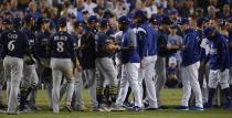 Both benches clear after Milwaukee Brewers' Jesus Aguilar and Los Angeles Dodgers' Manny Machado have words during the 10th inning of Game 4 of the National League Championship Series baseball game Tuesday, Oct. 16, 2018, in Los Angeles. (AP Photo/Mark J. Terrill)