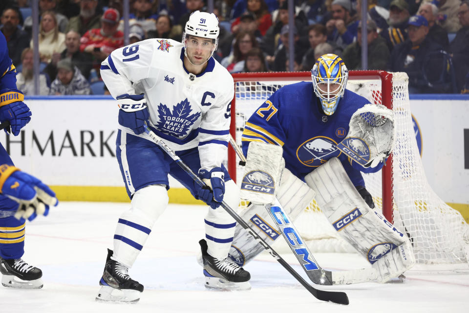 Toronto Maple Leafs center John Tavares (91) looks for a pass in front of Buffalo Sabres goaltender Devon Levi (27) during the second period of an NHL hockey game Thursday, Dec. 21, 2023, in Buffalo, N.Y. (AP Photo/Jeffrey T. Barnes)