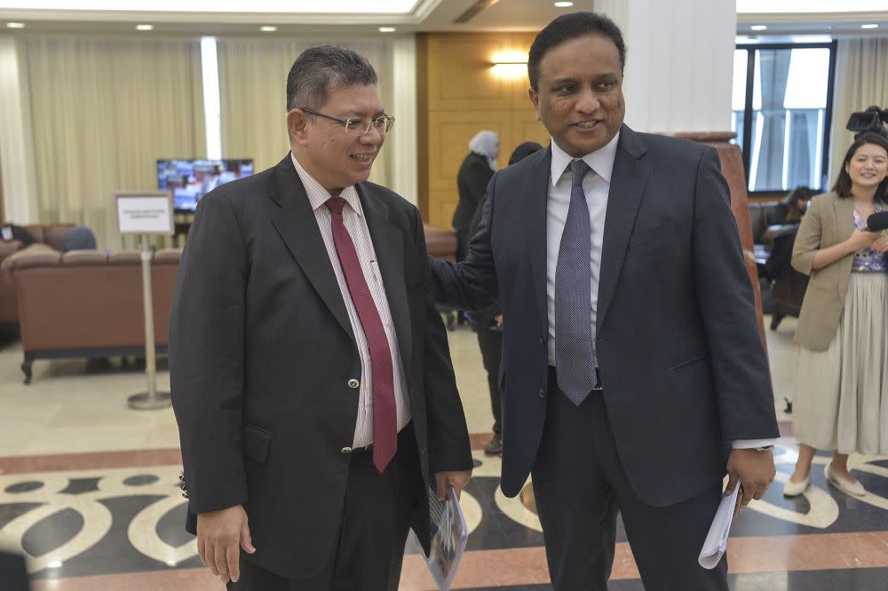 Foreign Affairs Datuk Saifuddin Abdullah shares a light moment with Kepala Batas MP Datuk Seri Reezal Merican (right) at Parliament November 7, 2019. — Picture by Shafwan Zaidon