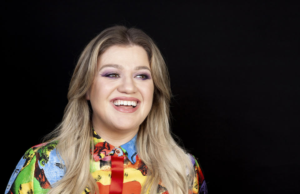 FILE - This April 14, 2019 file photo shows singer and actress Kelly Clarkson posing for a portrait at the Four Seasons Hotel in Los Angeles. Clarkson has been named the godmother of Norwegian Cruise Line’s newest ship Norwegian Encore, and the pop star said she signed on to the project because it aligned with the things that’s most important to her life: families spending time together, humanitarian work, and live music. (Photo by Rebecca Cabage/Invision/AP, File)