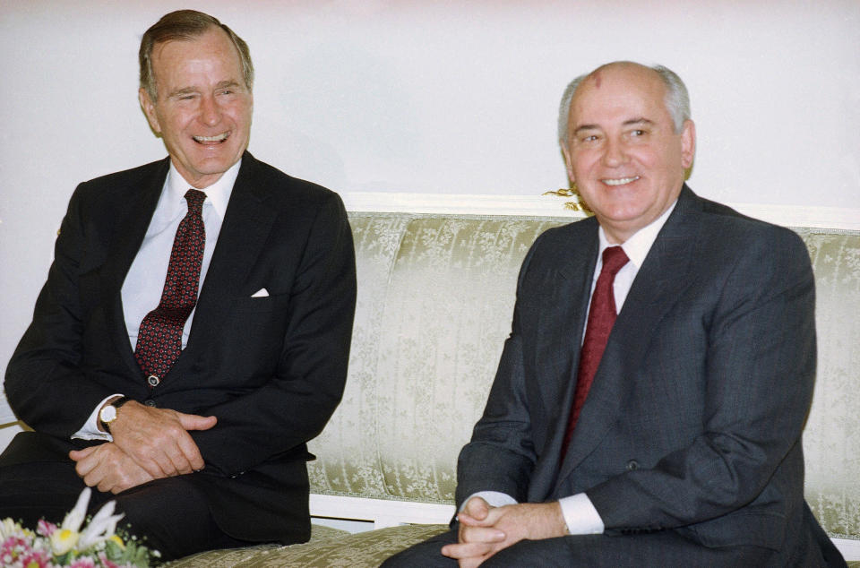 FILE - In this file photo taken on Tuesday, Oct. 29, 1991, U.S. President George H. Bush, left, and Soviet President Mikhail Gorbachev sit together at the Soviet Embassy after meeting in Madrid, Spain. Former Soviet premier Mikhail Gorbachev expressed his "deep condolences" Saturday Dec. 1, 2018, to the family of former U.S President George Bush and all Americans following his death, aged 94. (AP Photo/Liu Heung Shing, File)