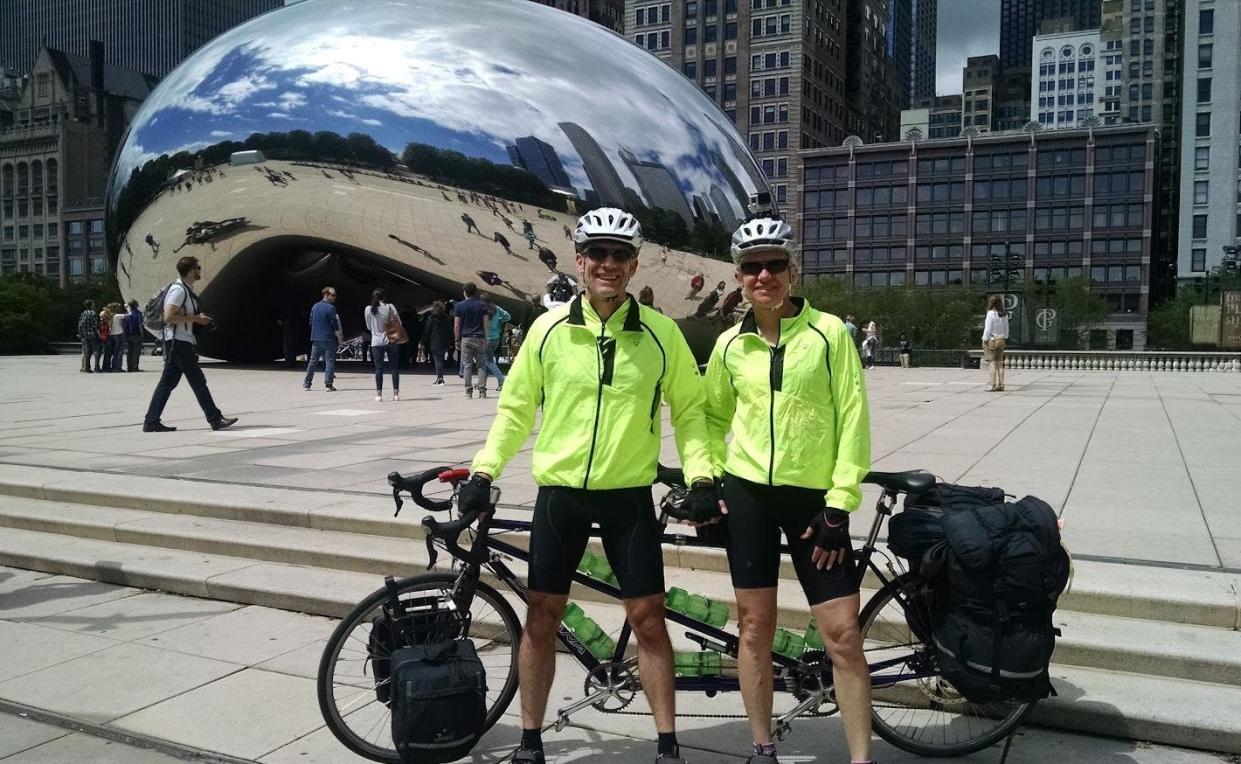 Peter and Tracy Flucke of Ashwaubenon stand in front of the iconic downtown Chicago sculpture "Cloud Gate" just before they begin their trek on the historic Route 66 on their tandem bicycle.