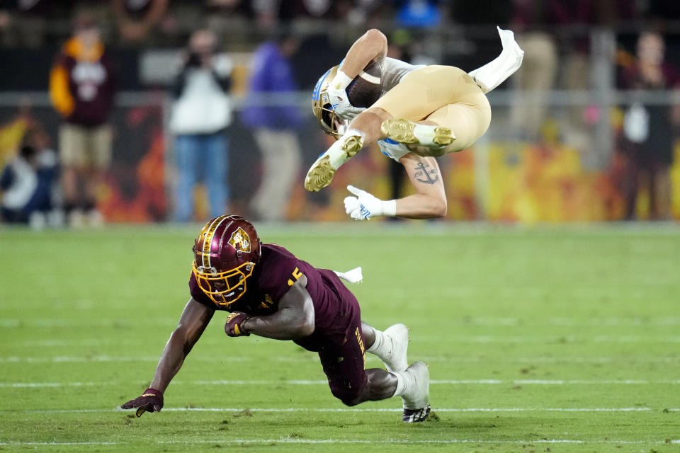 Arizona State defensive back Khoury Bethley (15) flips UCLA wide receiver Kazmeir Allen during the first half of an NCAA college football game in Tempe, Ariz., Saturday, Nov. 5, 2022. (AP Photo/Ross D. Franklin)