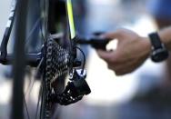 A Tinkoff-Saxo mechanic checks a bicycle before a training session in Utrecht, Netherlands, July 3, 2015. REUTERS/Eric Gaillard