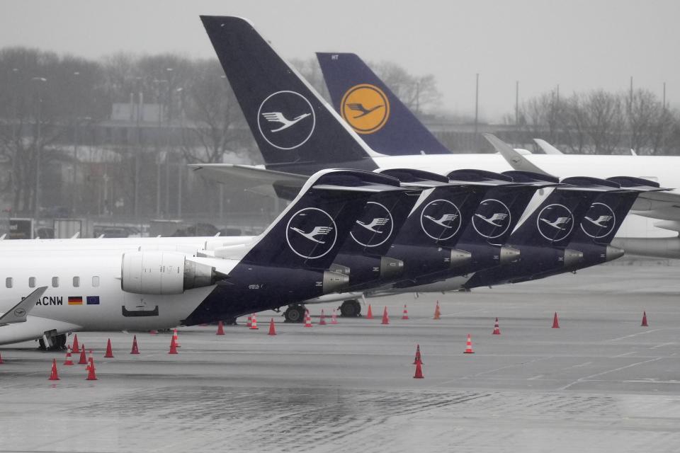 Aircrafts of the German airline Lufthansa are parked during a strike in Bavaria at the airport in Munich, Germany, Sunday, March 26, 2023. An increased number of travelers in Germany boarded trains and planes on Sunday to avoid a massive one-day strike Monday that's supposed to bring the country's transport system to a standstill. But even advance travels were met with disruptions in some places as Munich airport already shut down Sunday due to the strike and technical problems at Lufthansa in Frankfurt led to flight delays and cancellations at the country's biggest airport. (AP Photo/Matthias Schrader)