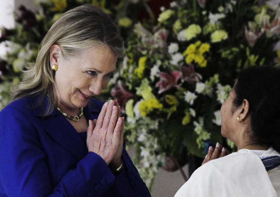 U.S. Secretary of State Hillary Rodham Clinton, left, and West Bengal Chief Minister Mamata Banerjee greet each other before a meeting in Kolkata, India, Monday, May 7, 2012. Clinton met with Banerjee, a key partner of India's ruling coalition who has stymied government efforts to lift restrictions on foreign-owned investments in the country. (AP Photo/Bikas Das)