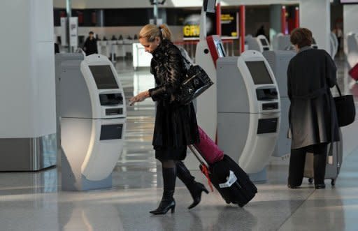 Passengers check in for their flights at the Qantas domestic airport terminal in Sydney on June 21, 2011. Qantas restored flights to and from the South Australian capital Adelaide before dawn Wednesday, followed by Melbourne. Canberra and Sydney routes were operating again by early afternoon, including international flights
