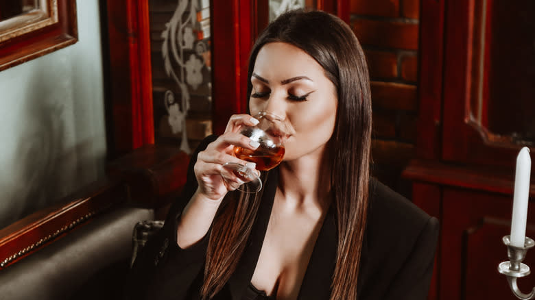Woman sipping brandy
