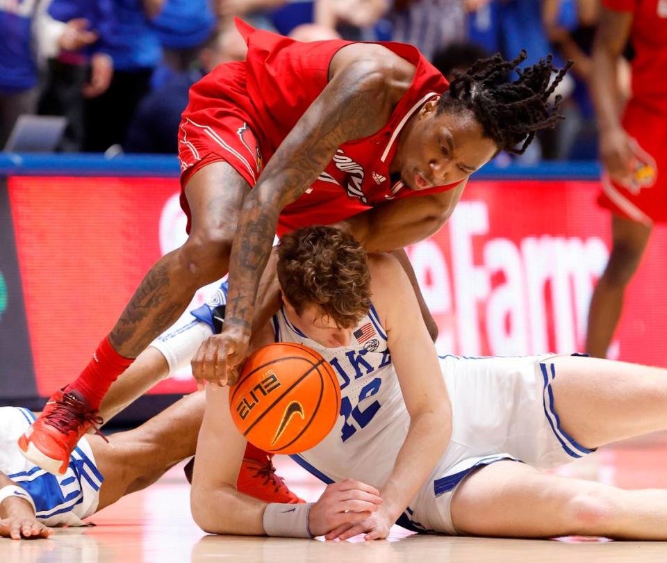 Duke’s TJ Power (12) battles for the loose ball with Louisville’s Mike James (0) during the second half of Duke’s 84-59 victory over Louisville at Cameron Indoor Stadium in Durham, N.C., Wednesday, Feb. 28, 2024.