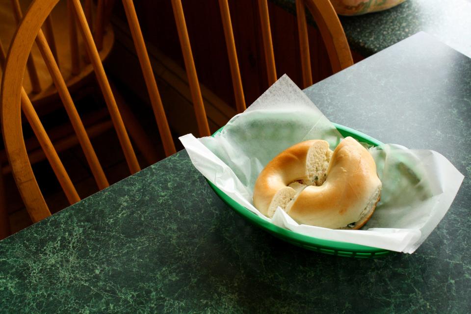 A plain bagel with chive and onion cream cheese from The Bagel Inn in Holden.