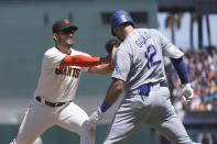 Los Angeles Dodgers' Joey Gallo (12) is tagged by San Francisco Giants first baseman David Villar after grounding out during the fifth inning of a baseball game in San Francisco, Thursday, Aug. 4, 2022. (AP Photo/Jeff Chiu)