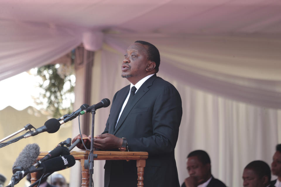 Kenyan President Uhuru Kenyatta delivers a speech during the funeral ceremony of the late former Zimbabwean leader, Robert Mugabe at the National Sports stadium in Harare, Saturday,Sept, 14, 2019. African heads of state and envoys are gathering to attend a state funeral for Mugabe, whose burial has been delayed for at least a month until a special mausoleum can be built for his remains.  (AP Photo/Tsvangirayi Mukwazhi)