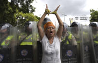 <p>A woman protests in front of a line of Bolivarian National Police during an opposition demonstration in Caracas, June 7, 2016. (AP/Ariana Cubillos) </p>