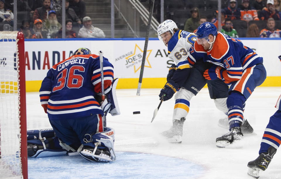 St. Louis Blues' Jake Neighbours (63) is stopped by Edmonton Oilers goalie Jack Campbell (36) as Oilers' Brett Kulak (27) defends during the third period of an NHL game in Edmonton, Alberta, Saturday, Oct. 22, 2022. (Jason Franson/The Canadian Press via AP)